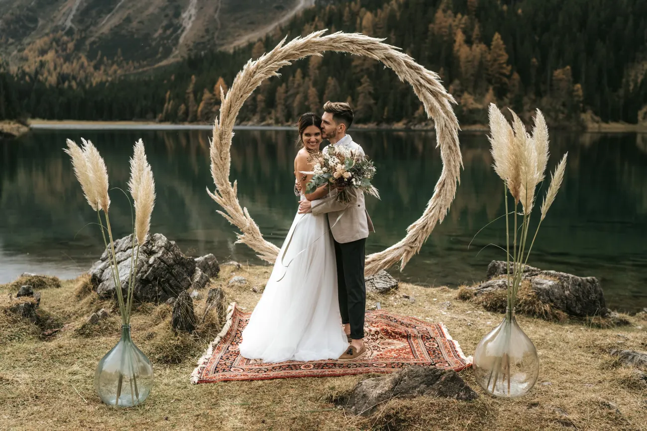 The couple at the arch beside the still Tyrolean lake