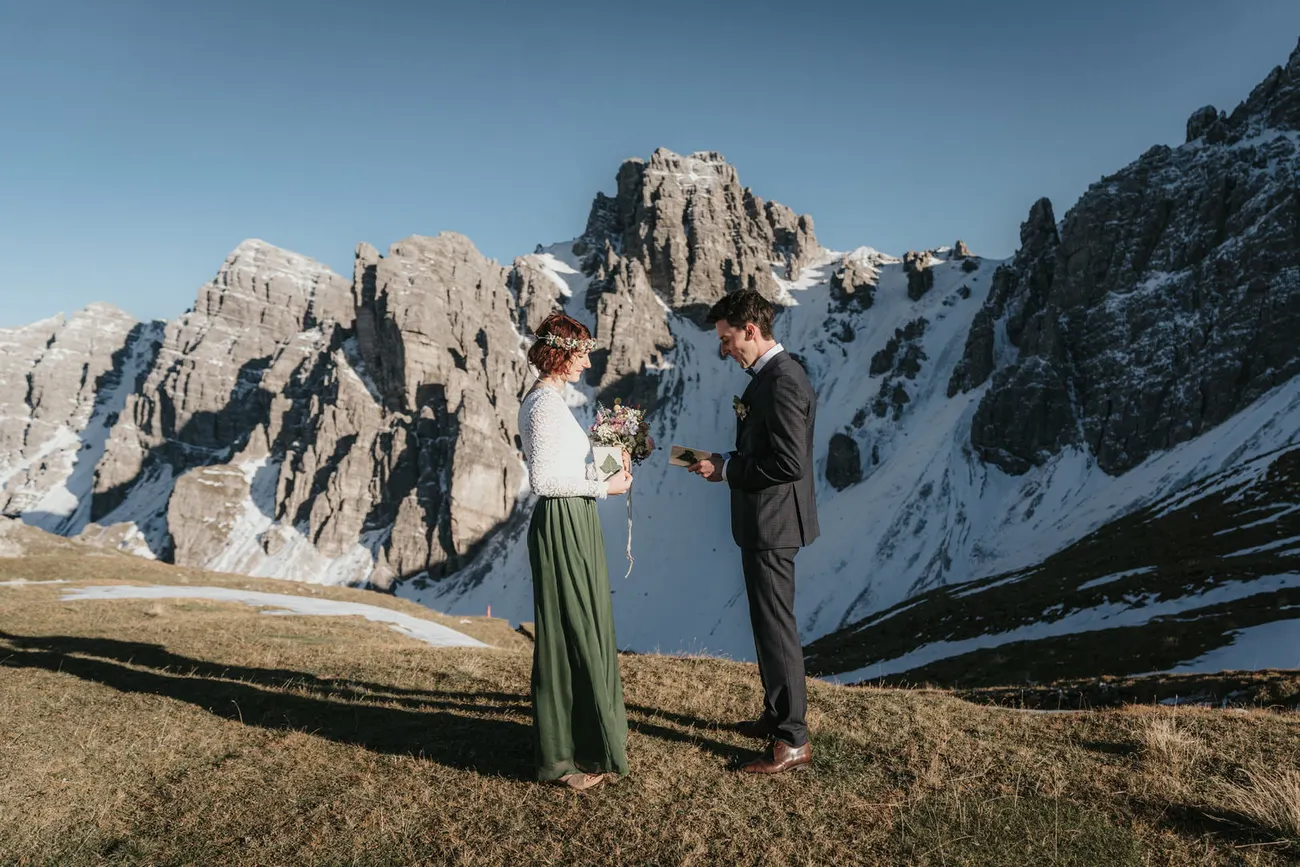 A ceremony in Tyrol with a backdrop of snow-streaked jagged peaks