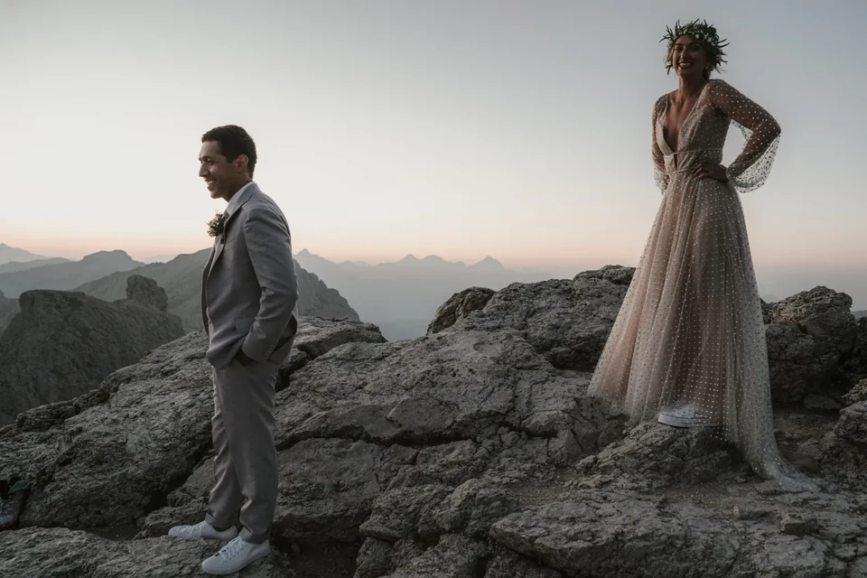 Bride and groom on a ridge at first light near the Sella