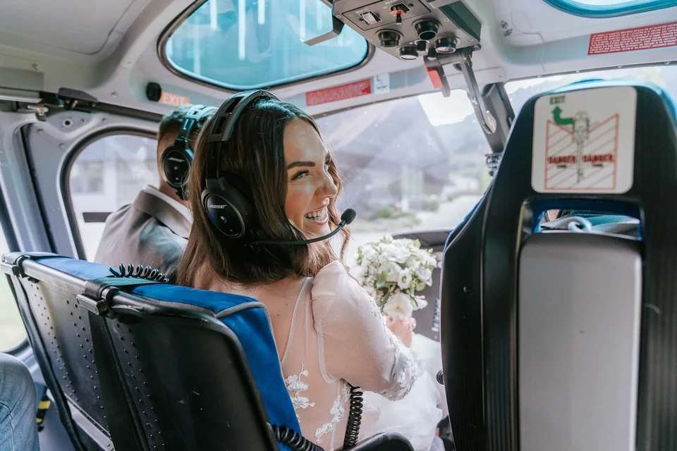 Bride with a headset inside the helicopter before take-off