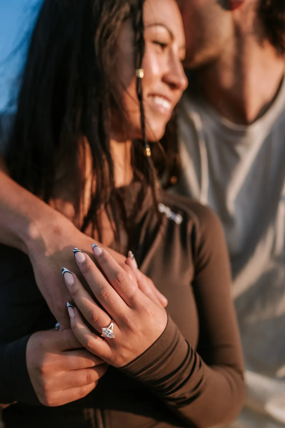 The new ring resting on his shoulder during an embrace